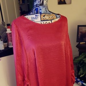 Red satiny polyester top.